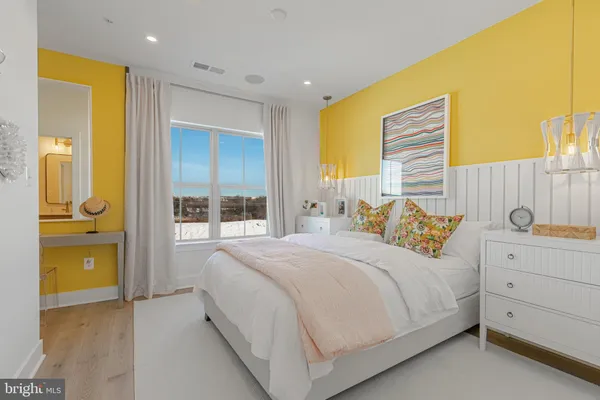 a bedroom with a bed and a night stand