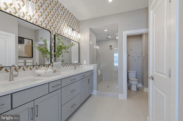 a bathroom with a double vanity sink and mirror with shower