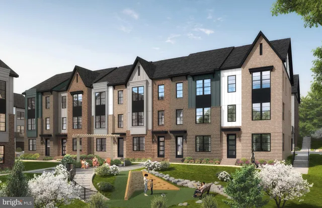 a front view of a residential apartment building with a yard