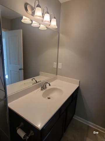 a bathroom with a sink a vanity and a mirror