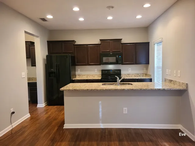 a kitchen with stainless steel appliances a refrigerator a stove and a sink