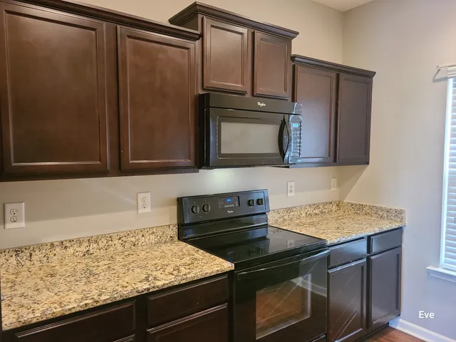 a kitchen with granite countertop cabinets and steel stainless steel appliances
