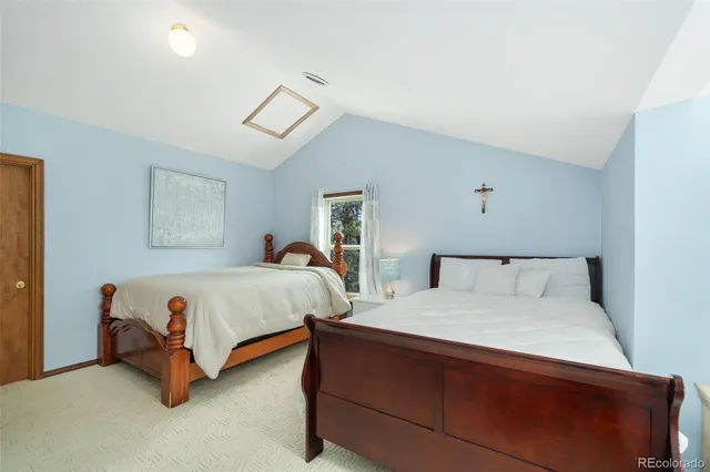 a bedroom with a bed and a night stand