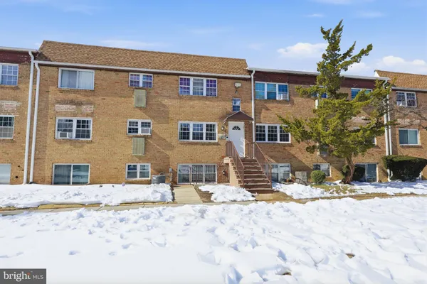 a view of a house with snow on the road