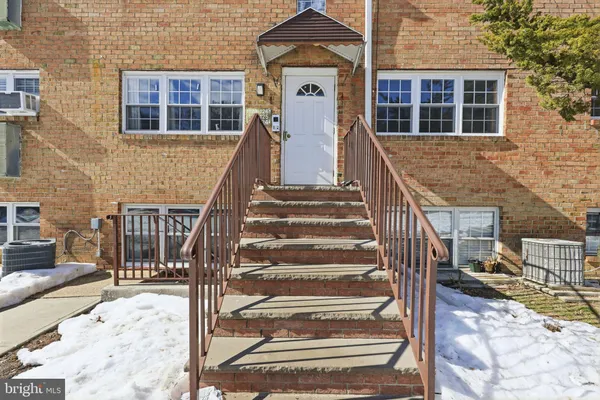 a view of a brick house with wooden floor and white walls