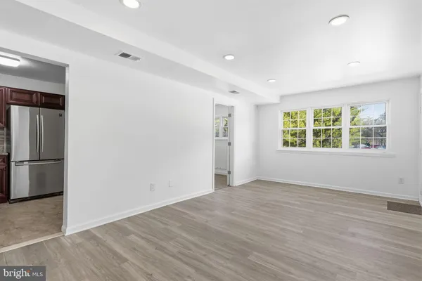 an empty room with windows and closet