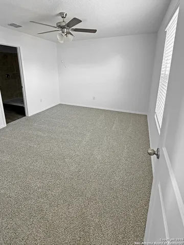 wooden floor in an empty room with a bathroom