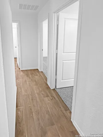 a view of a room with wooden floor and closet