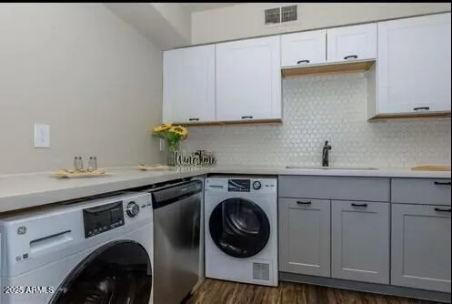 a utility room with sink dryer and washer