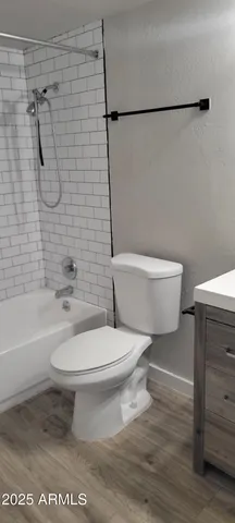 a white toilet sitting next to a bath tub