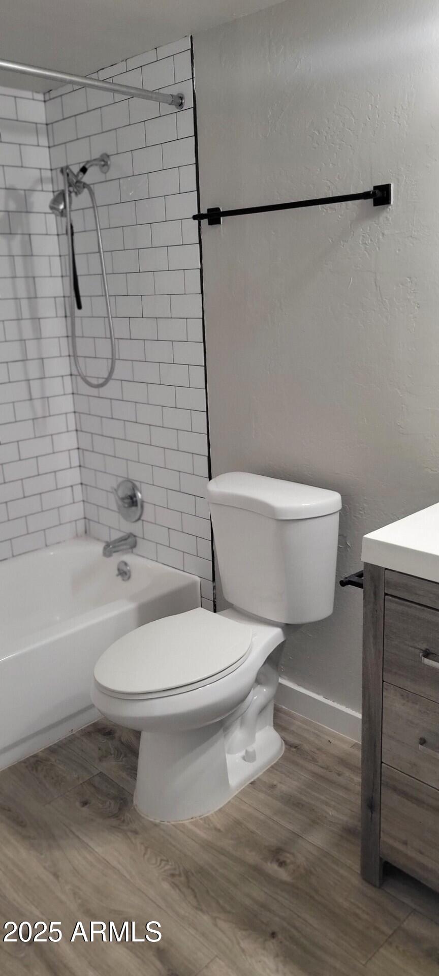 2339 West Northern Avenue, Unit 225 Phoenix, AZ 85021 - Photo 7 of 14 a white toilet sitting next to a bath tub