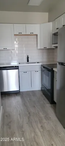 a kitchen with a stove and white cabinets