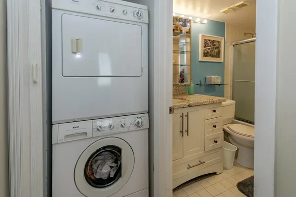 a bathroom with a granite countertop toilet and a shower