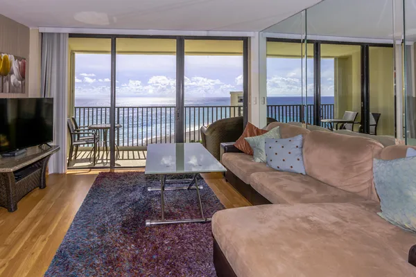 a living room with large windows and a flat screen tv