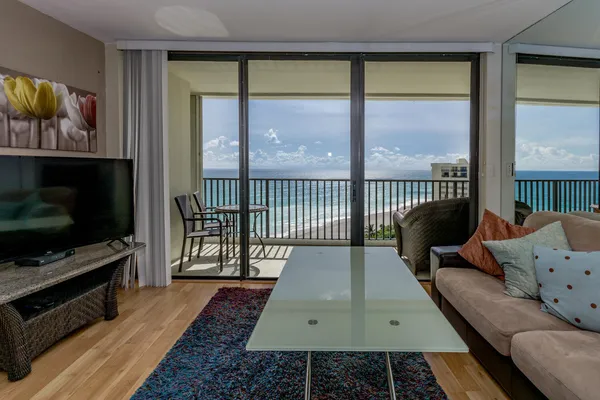a living room with furniture tv and a flat screen tv