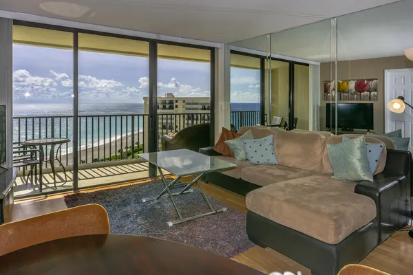 a living room with furniture and a floor to ceiling window