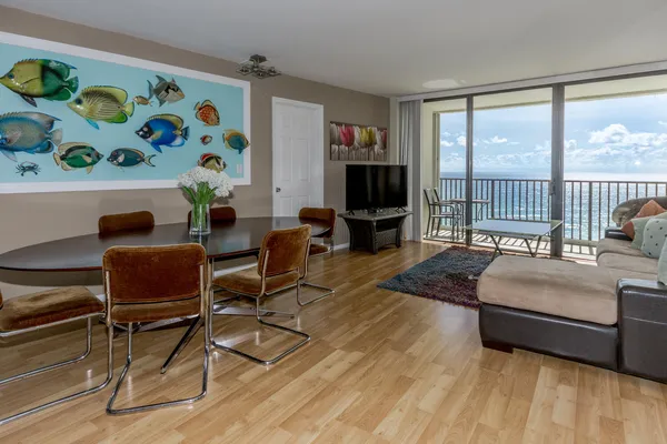 a living room with furniture and a floor to ceiling window