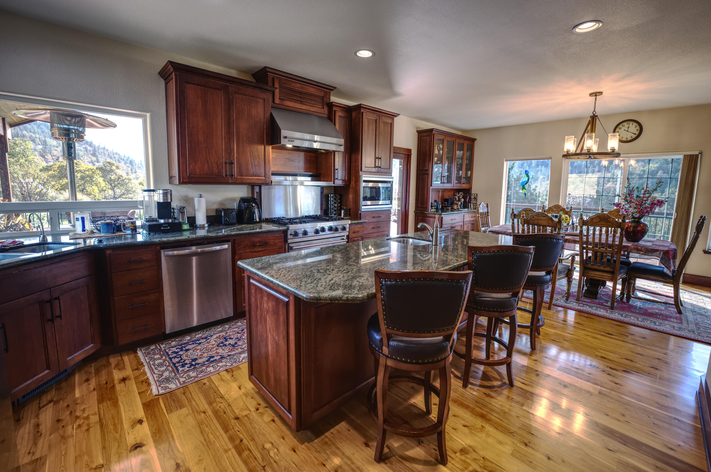 6555 East Antelope Road Eagle Point, OR 97524 - Photo 14 of 30 a kitchen with stainless steel appliances granite countertop a stove a sink a microwave dining table and chairs
