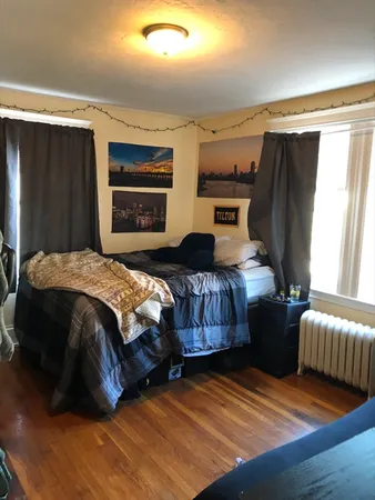 a bedroom with bed and a window