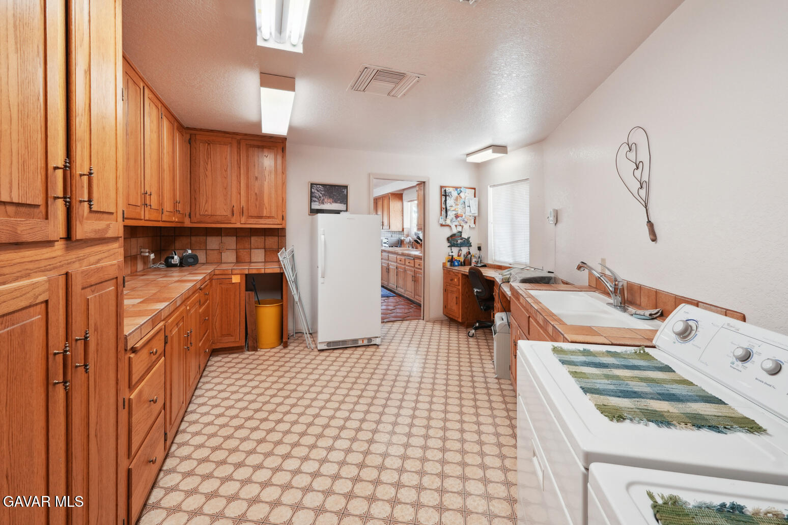 6020 Valley Sage Road Acton, CA 93510 - Photo 14 of 40 a kitchen with stainless steel appliances a stove a sink and a refrigerator
