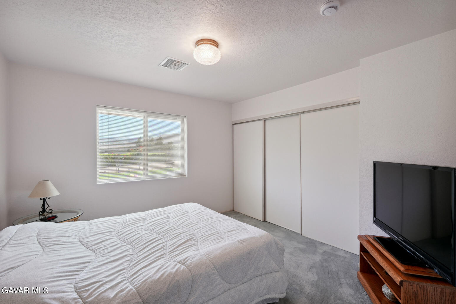 6020 Valley Sage Road Acton, CA 93510 - Photo 20 of 40 a bedroom with a bed and a flat tv screen on a dresser