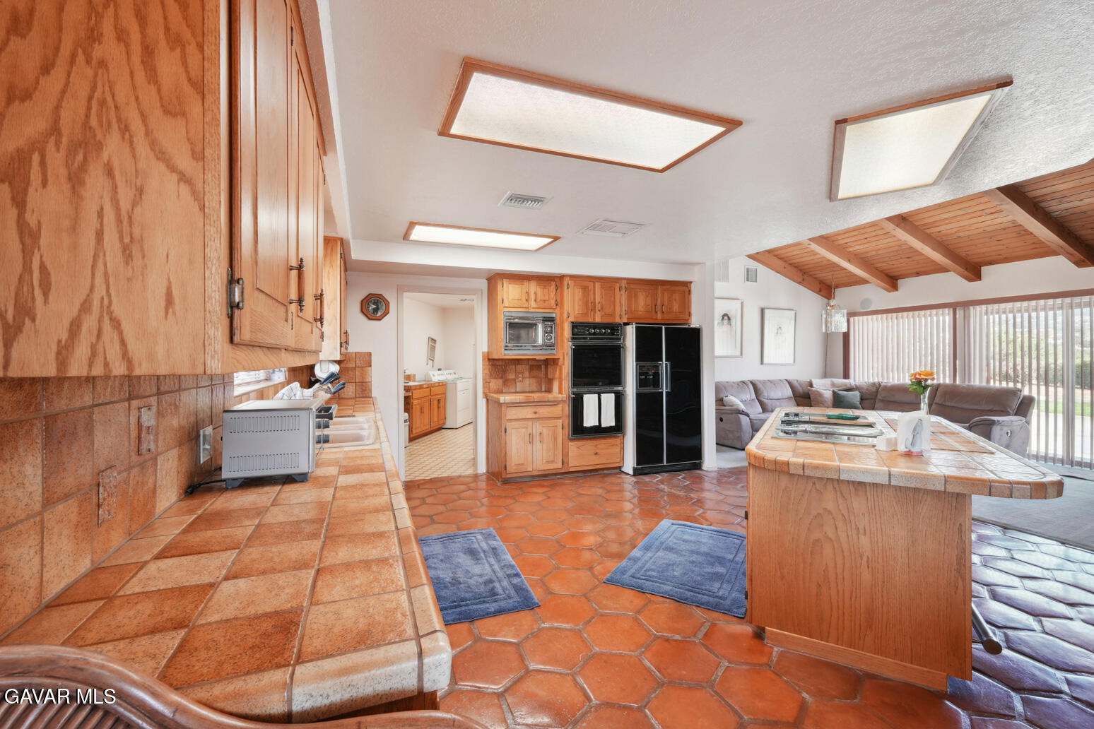 6020 Valley Sage Road Acton, CA 93510 - Photo 6 of 40 a large kitchen with kitchen island a stove a sink and a dining table view