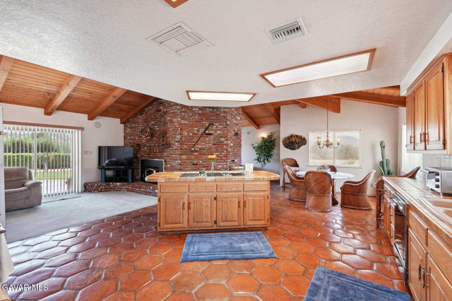 6020 Valley Sage Road Acton, CA 93510 - Photo 9 of 40 a large kitchen with a stove a sink dishwasher and a fireplace with wooden floor