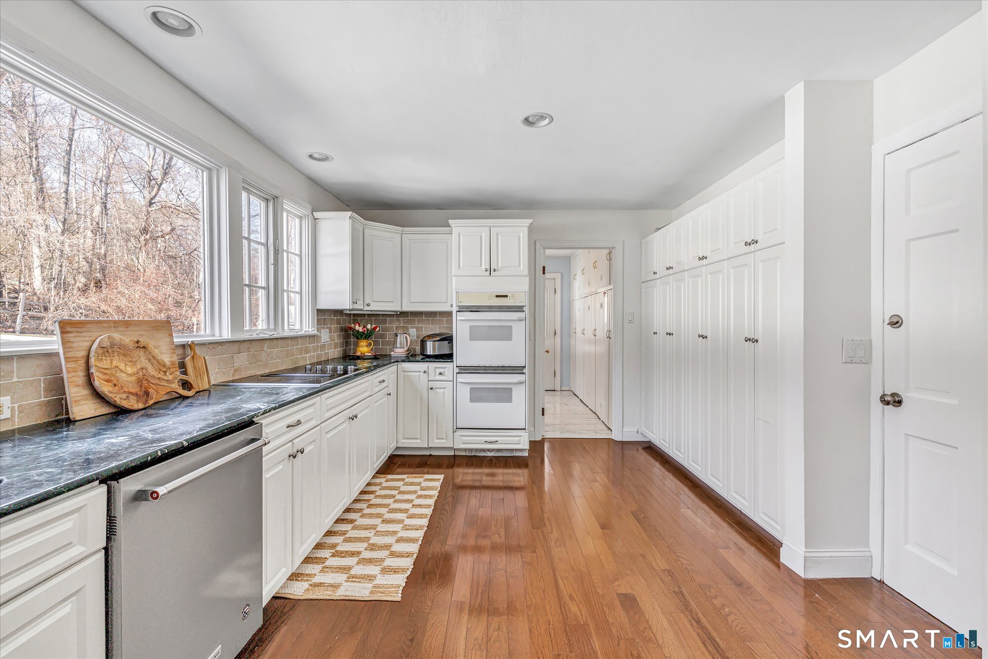39 Marion Road Westport, CT 06880 - Photo 18 of 46 a kitchen with granite countertop wooden floors appliances and window