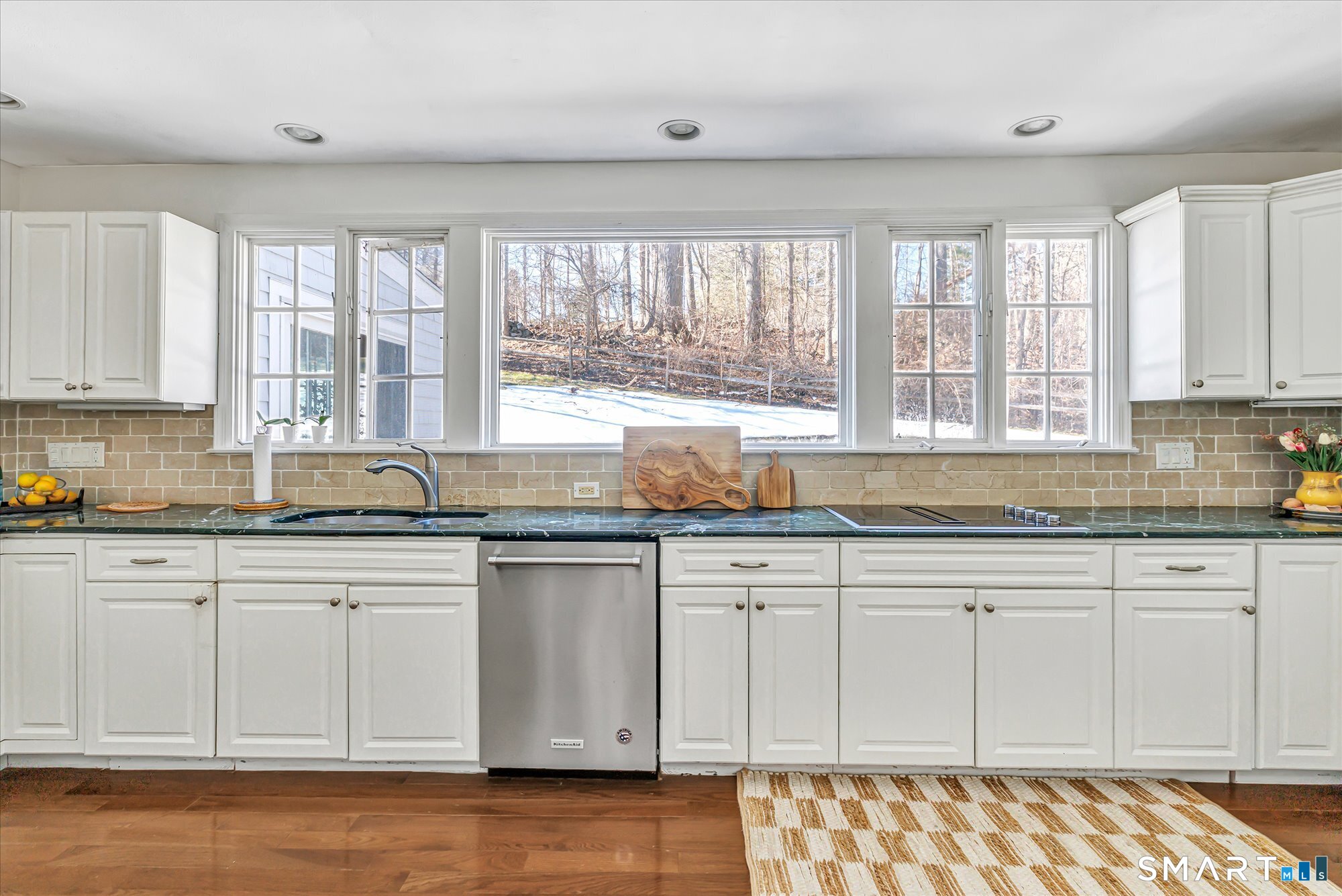 39 Marion Road Westport, CT 06880 - Photo 19 of 46 a kitchen with granite countertop white cabinets white appliances with a sink and dishwasher