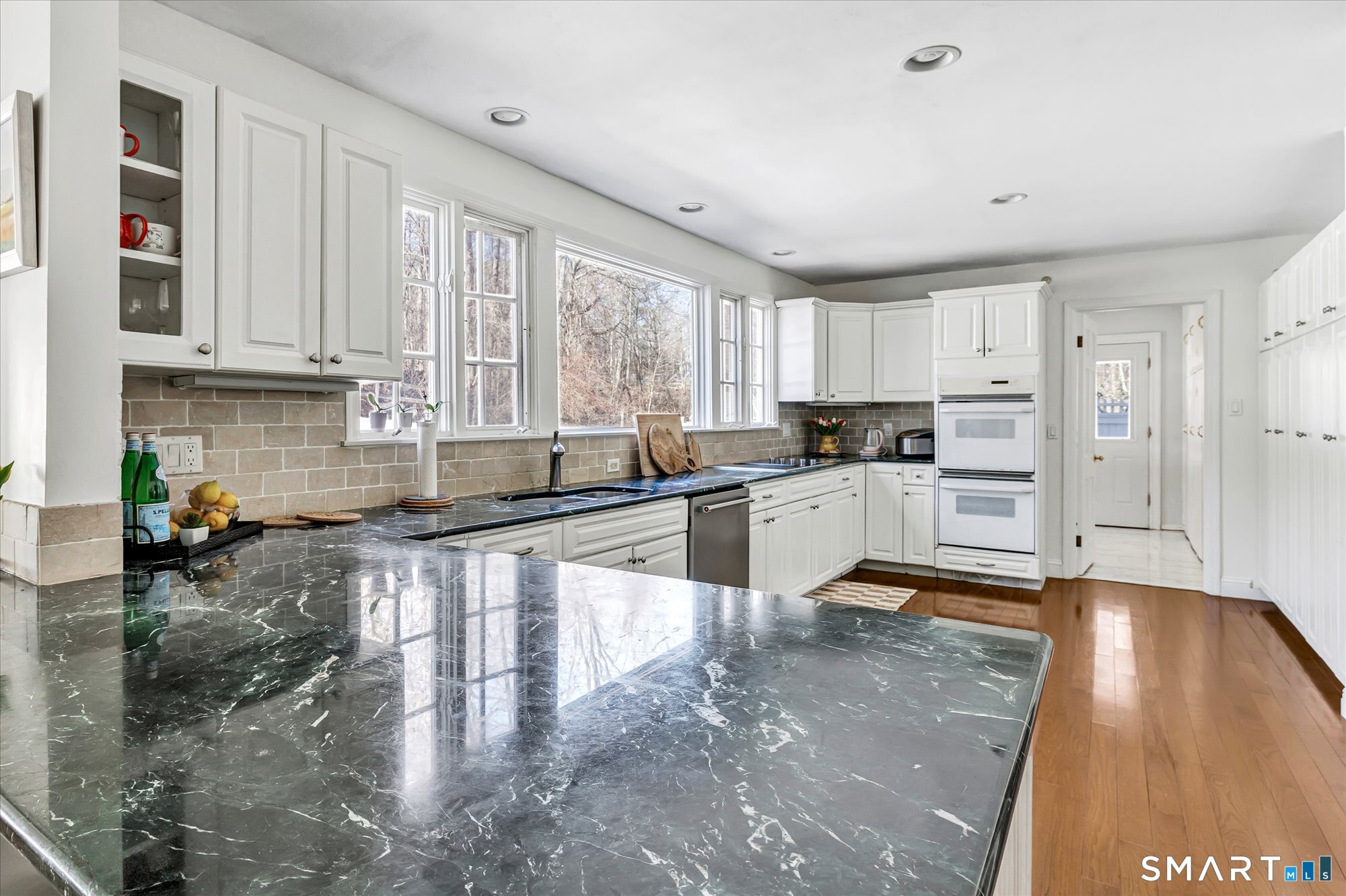 39 Marion Road Westport, CT 06880 - Photo 21 of 46 a kitchen with stainless steel appliances granite countertop a stove a sink and white cabinets