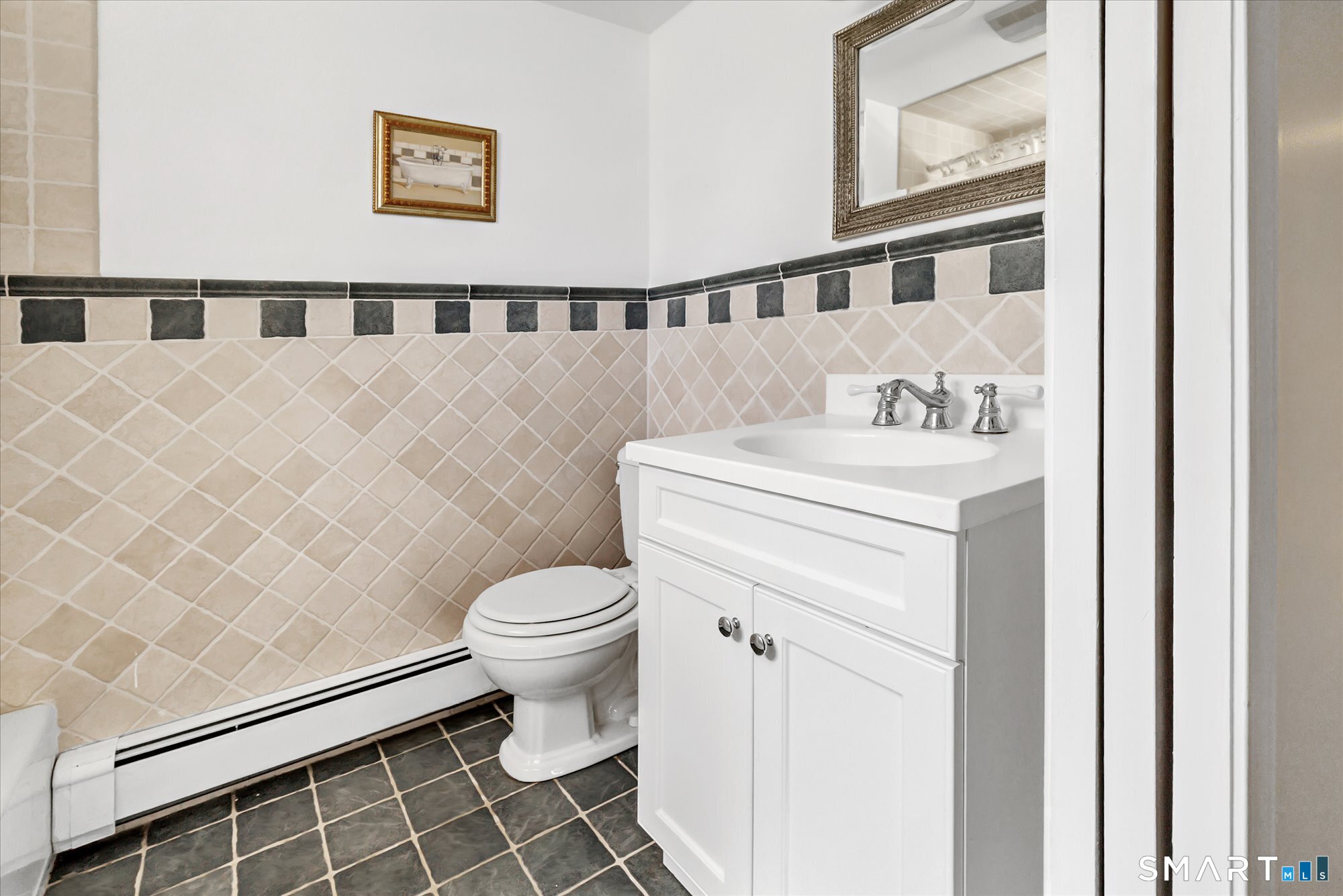 39 Marion Road Westport, CT 06880 - Photo 40 of 46 a bathroom with a sink a toilet and a mirror