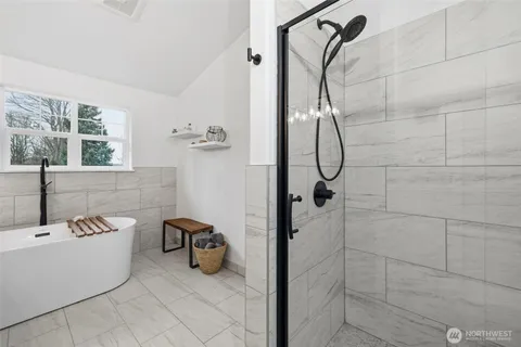 a bathroom with a bath tub with shower