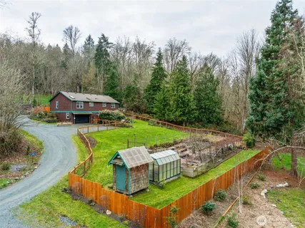 a view of a house with swimming pool and yard with green space