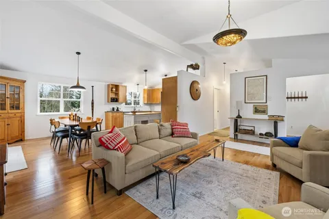 a living room with furniture and kitchen view