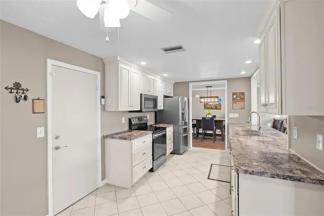 a kitchen with stainless steel appliances granite countertop a refrigerator oven stove a sink and dishwasher