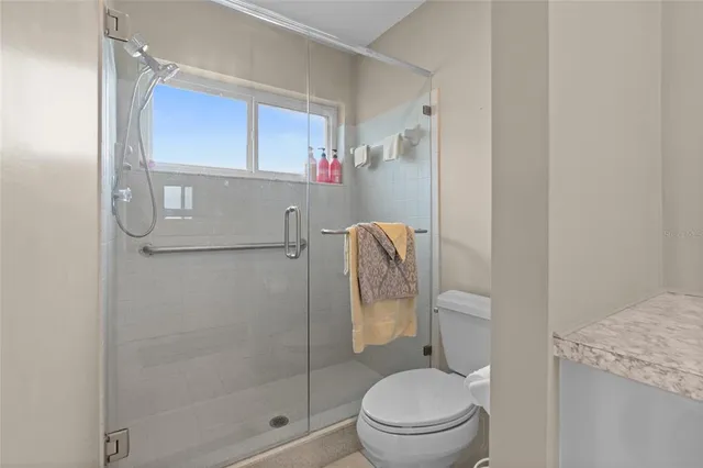 a bathroom with a toilet and a shower