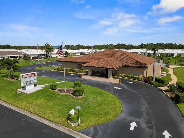 an aerial view of a house with garden space and street view
