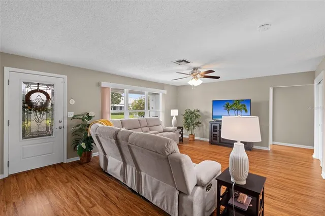 a living room with furniture and wooden floor
