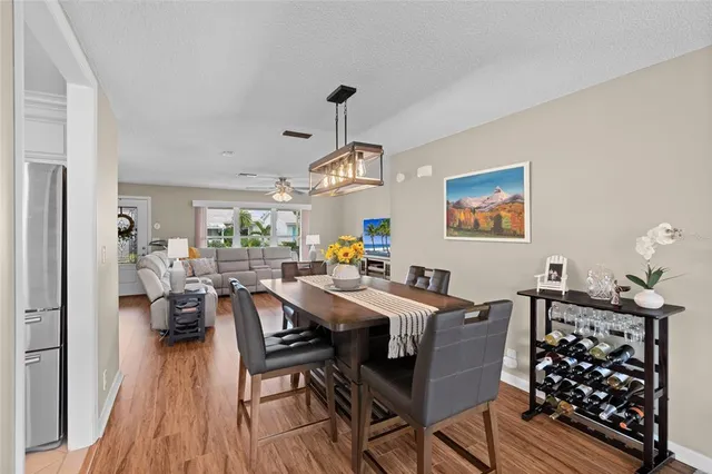 a view of a dining room with furniture wooden floor and chandelier