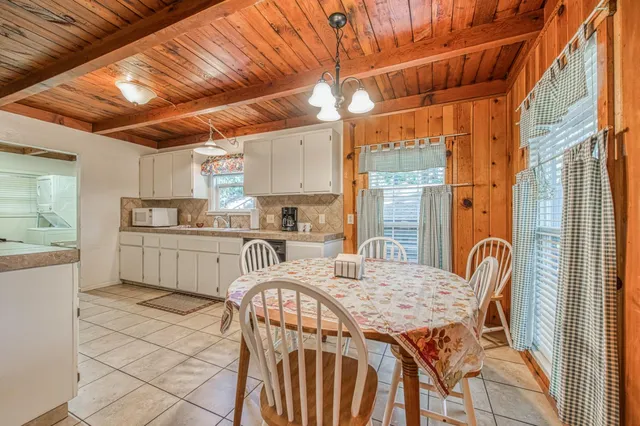 a kitchen that has a table and chairs in it