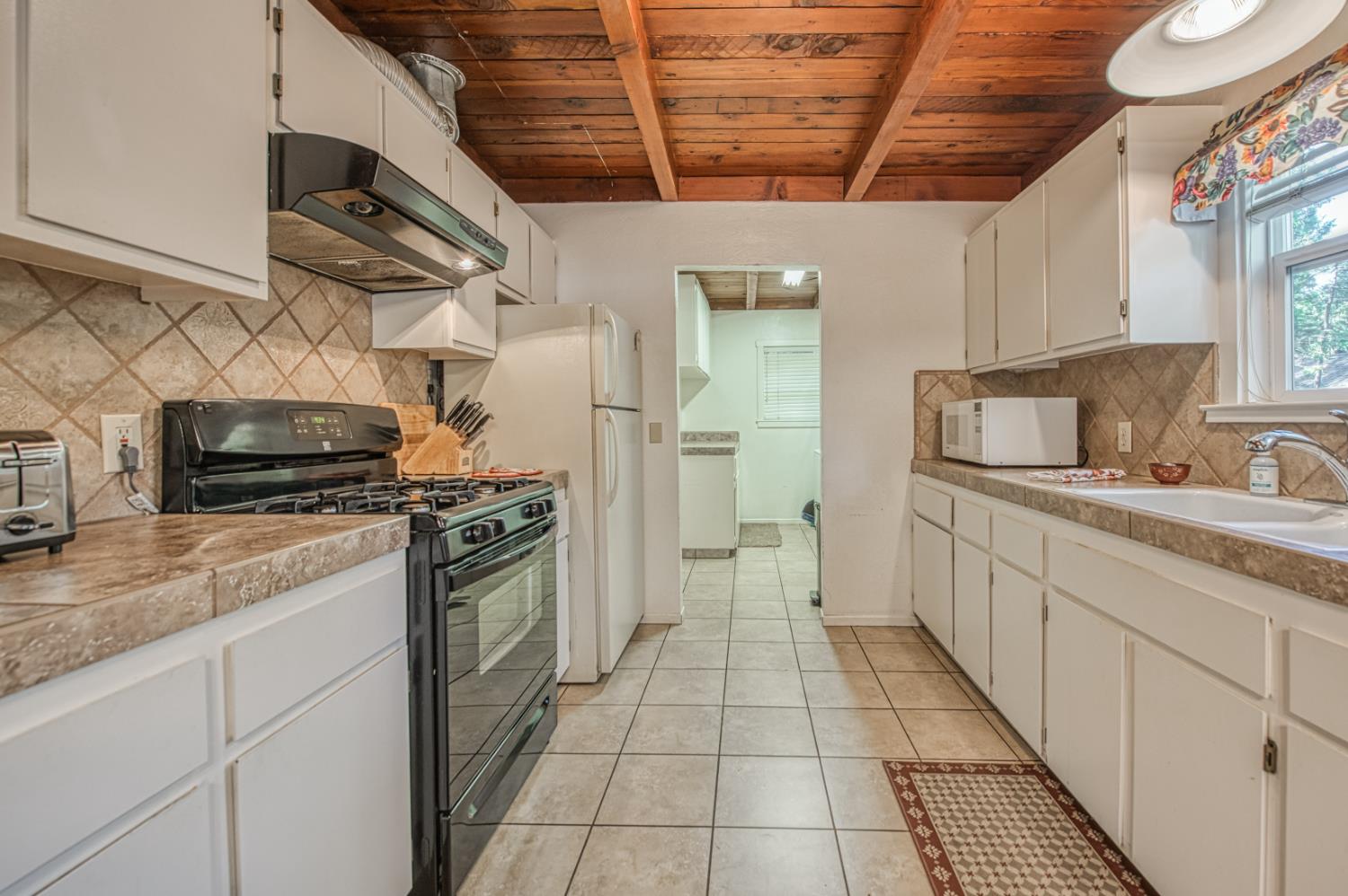 42088 North Elderberry Road Shaver Lake, CA 93664 - Photo 12 of 49 a kitchen with stainless steel appliances granite countertop a stove a sink and a refrigerator