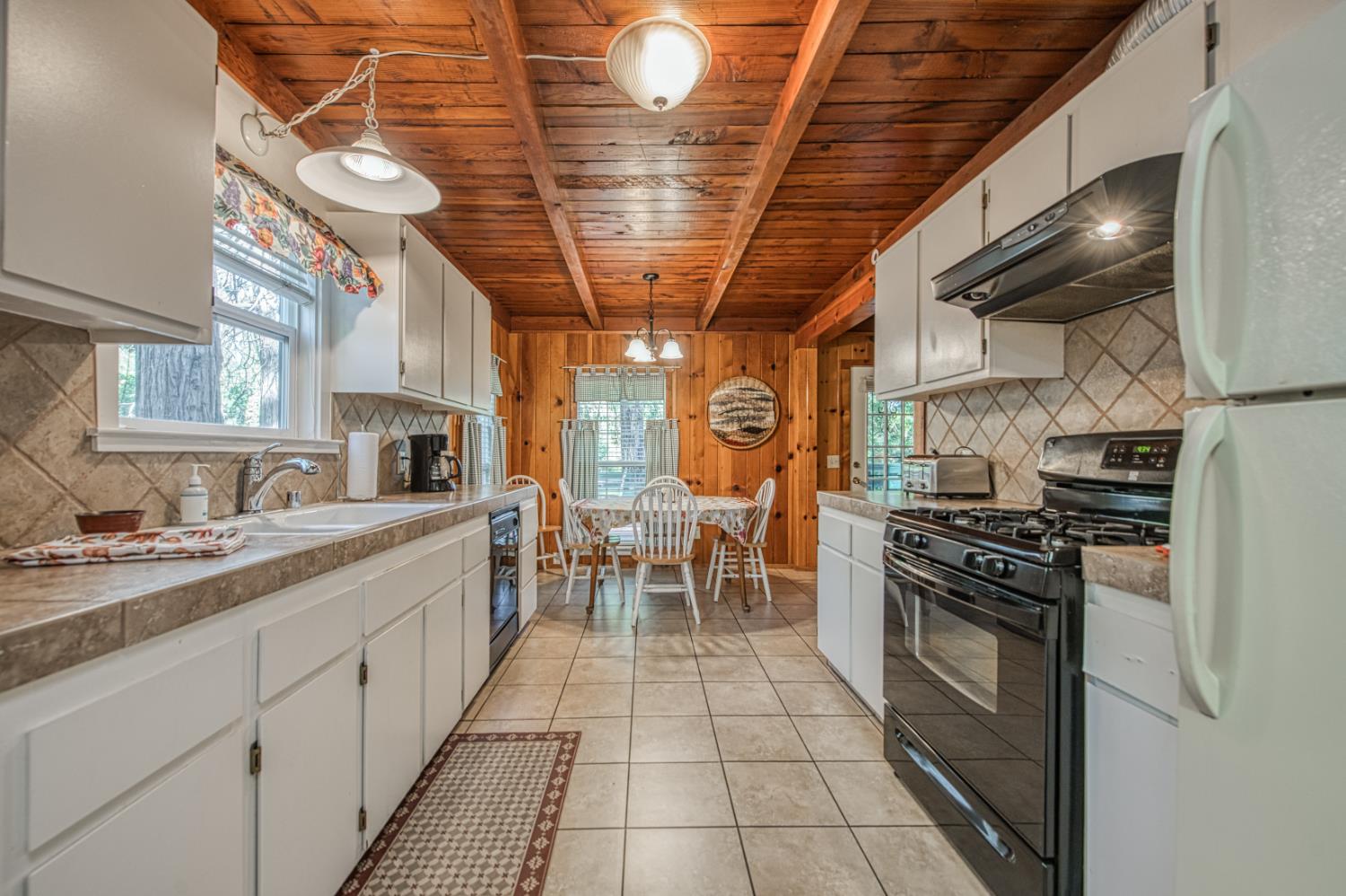 42088 North Elderberry Road Shaver Lake, CA 93664 - Photo 14 of 49 a kitchen with stainless steel appliances granite countertop a stove a sink and dishwasher