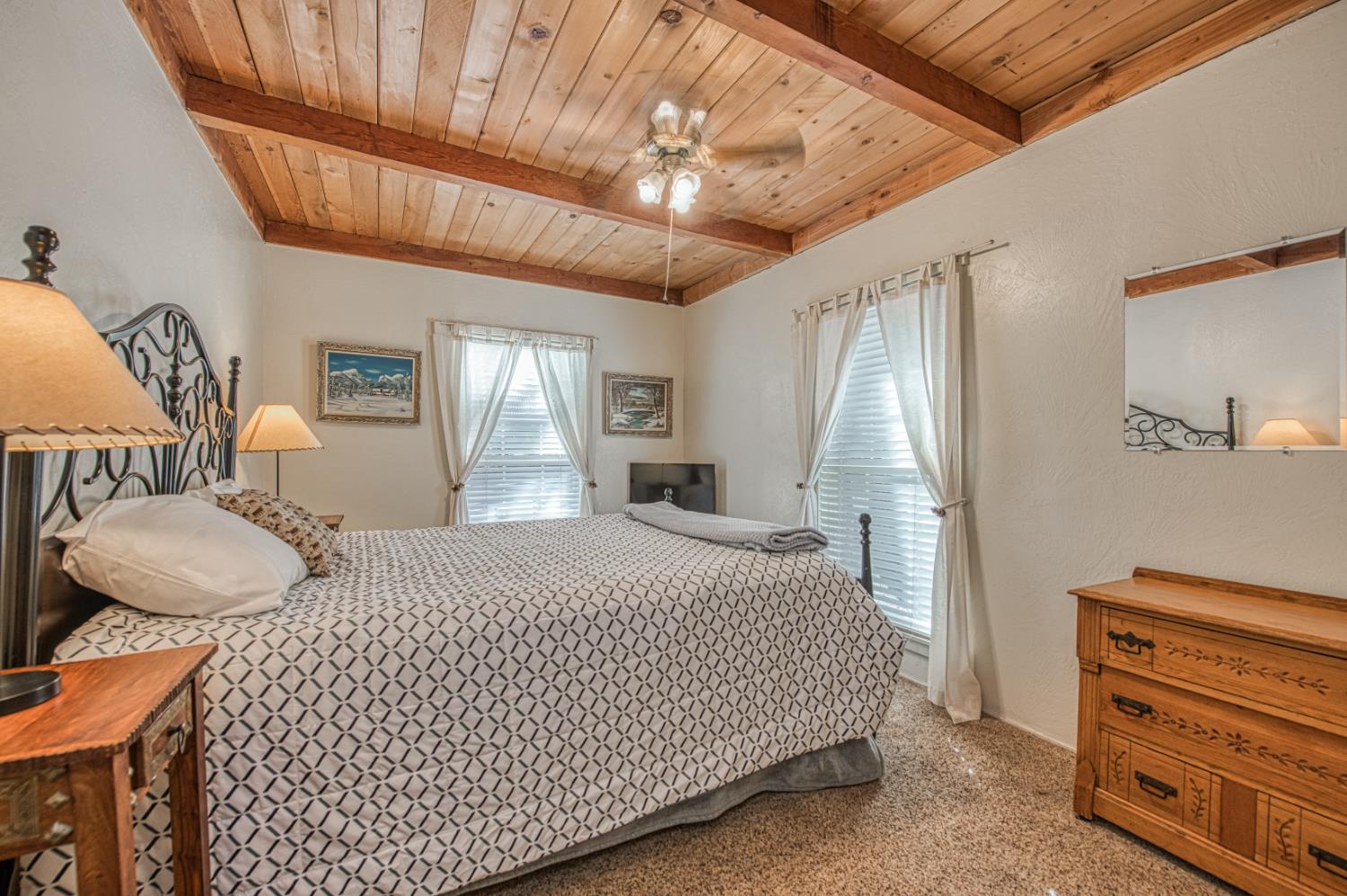 42088 North Elderberry Road Shaver Lake, CA 93664 - Photo 17 of 49 a bedroom with a bed and dresser with mirror