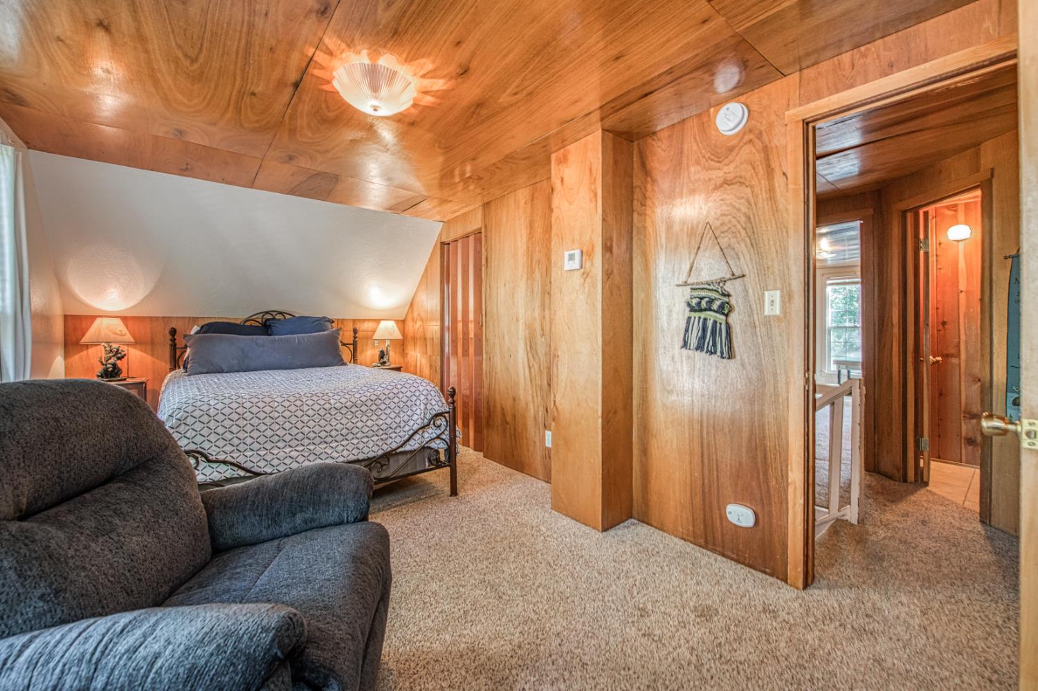 42088 North Elderberry Road Shaver Lake, CA 93664 - Photo 22 of 49 a living room with a couch and a chandelier
