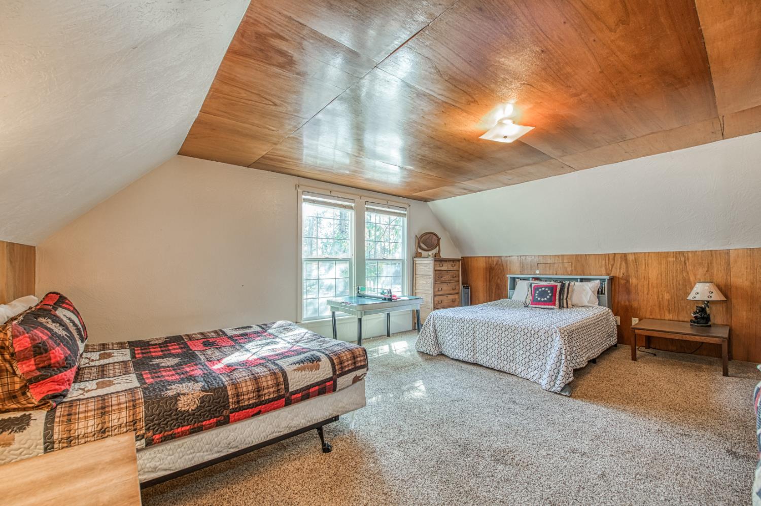 42088 North Elderberry Road Shaver Lake, CA 93664 - Photo 25 of 49 a spacious bedroom with a bed and window