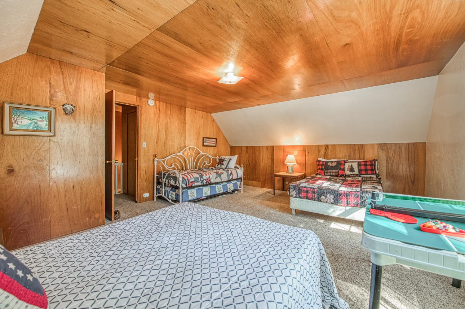 42088 North Elderberry Road Shaver Lake, CA 93664 - Photo 26 of 49 a bed room with a bed and a chair