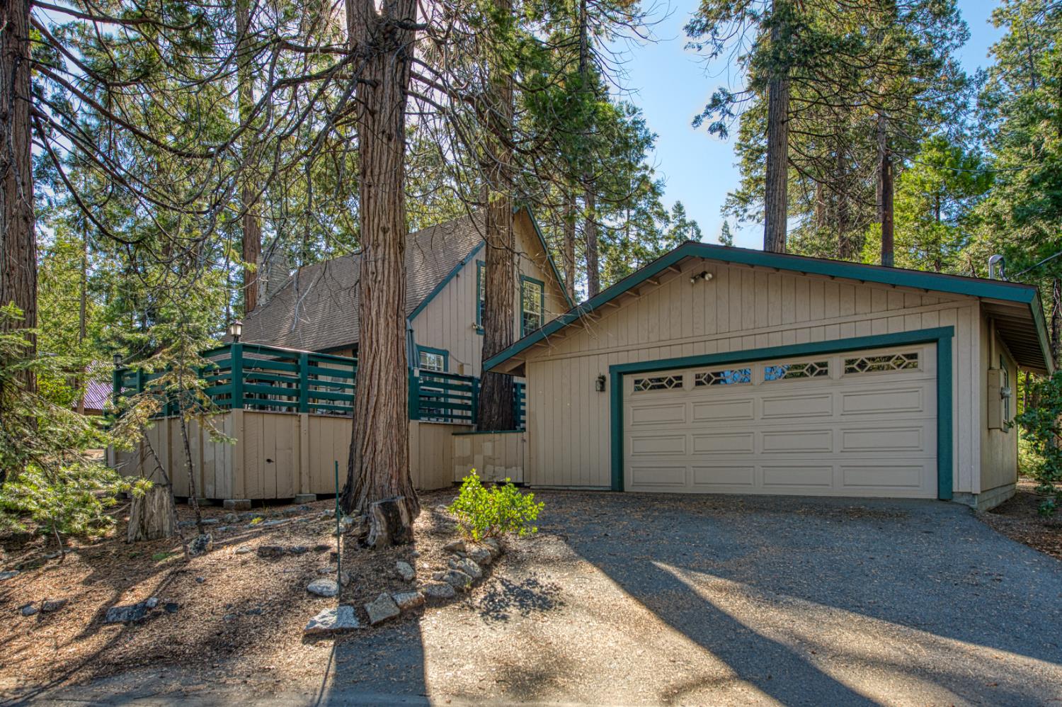 42088 North Elderberry Road Shaver Lake, CA 93664 - Photo 31 of 49 a view of a house with a yard and garage