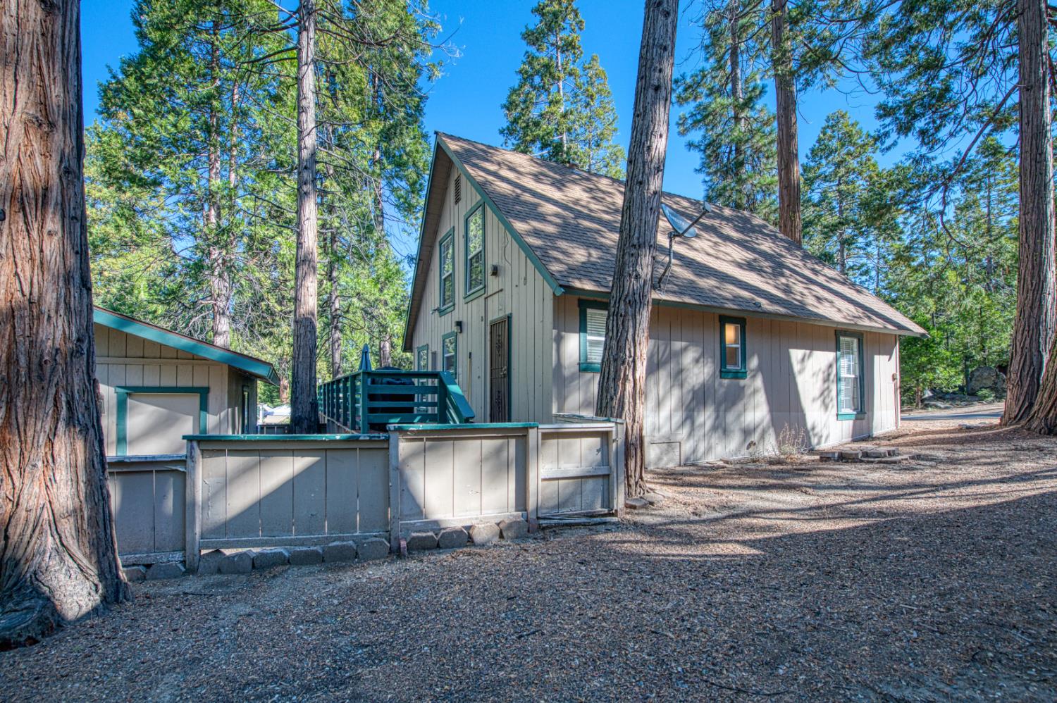 42088 North Elderberry Road Shaver Lake, CA 93664 - Photo 33 of 49 a view of a house with a yard next to a large tree