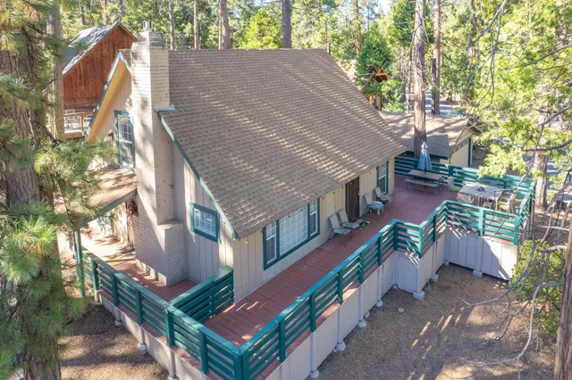 a aerial view of a house with a yard and potted plants