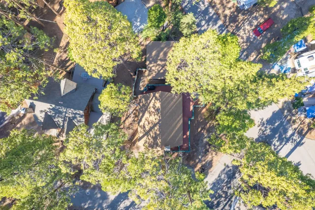 a view of a lush green field with mountains in the background